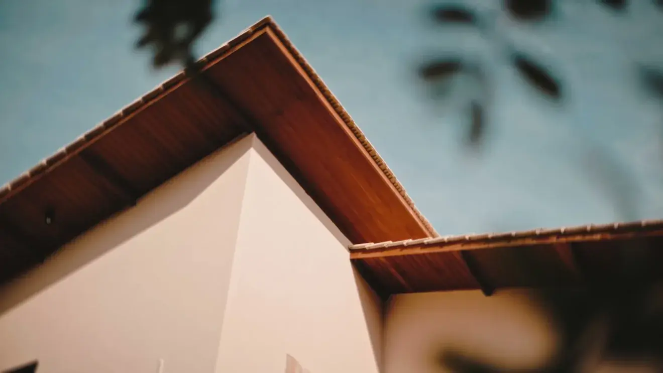 Close view of a finished roof edge and eave against a clear sky