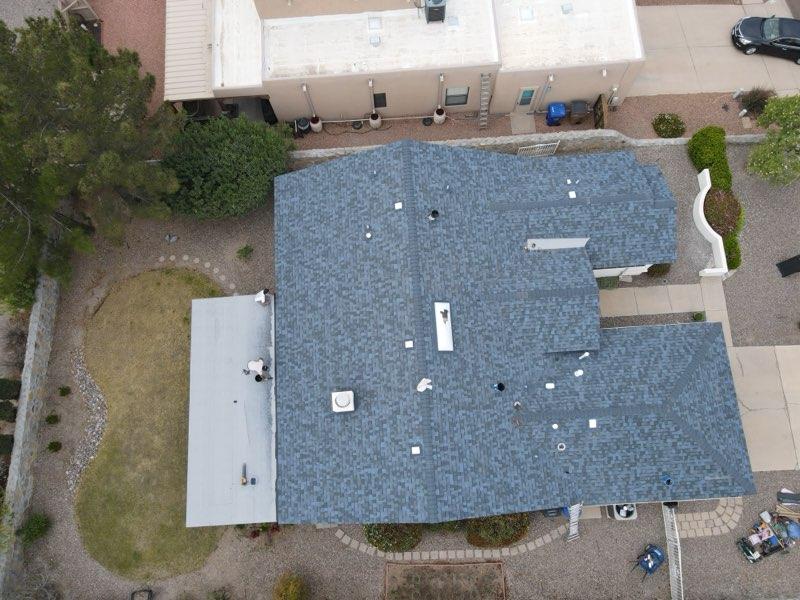 Detailed aerial view of asphalt shingle roofing texture