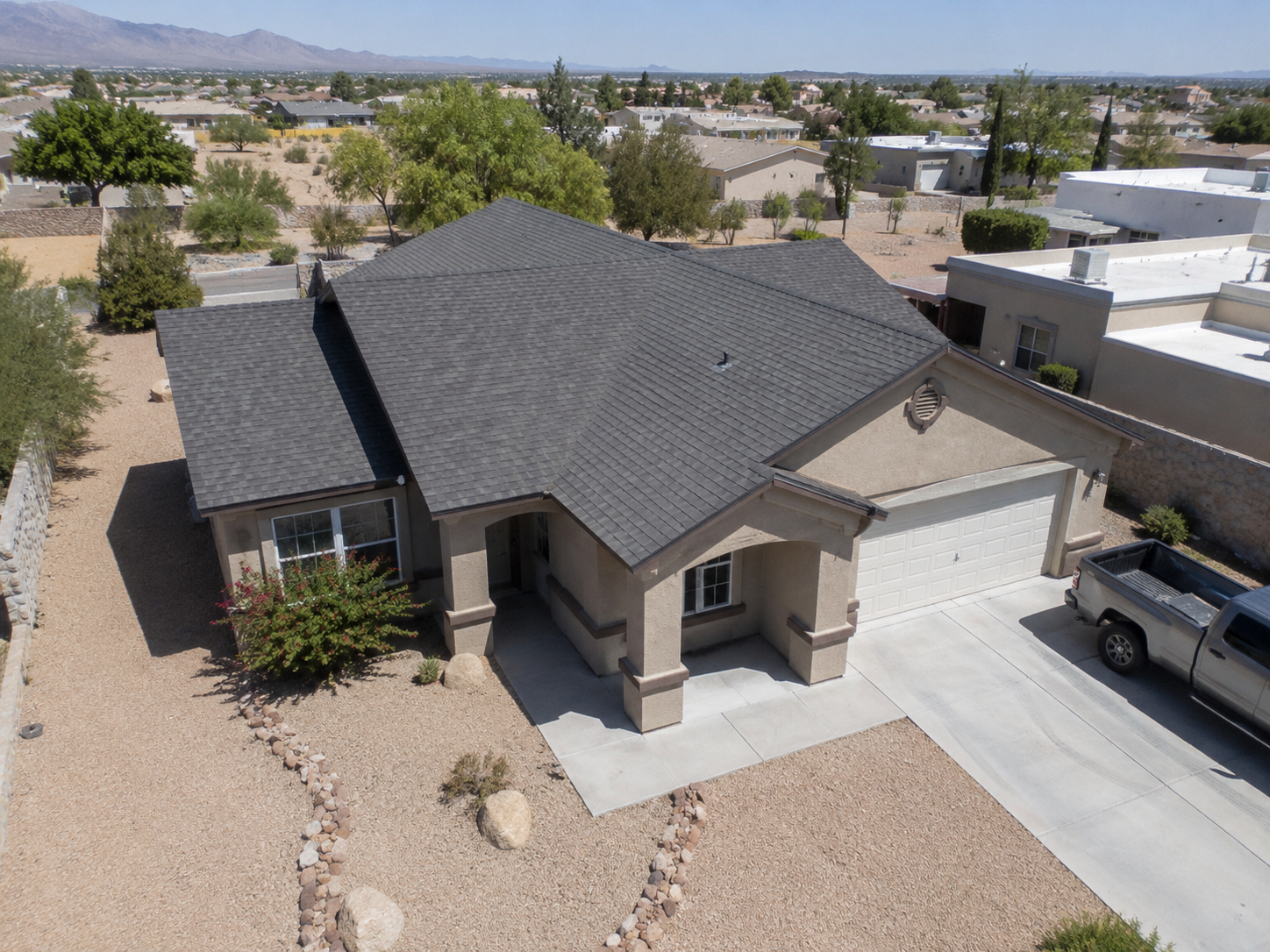 Aerial view of a Southwest home with an asphalt shingle roof
