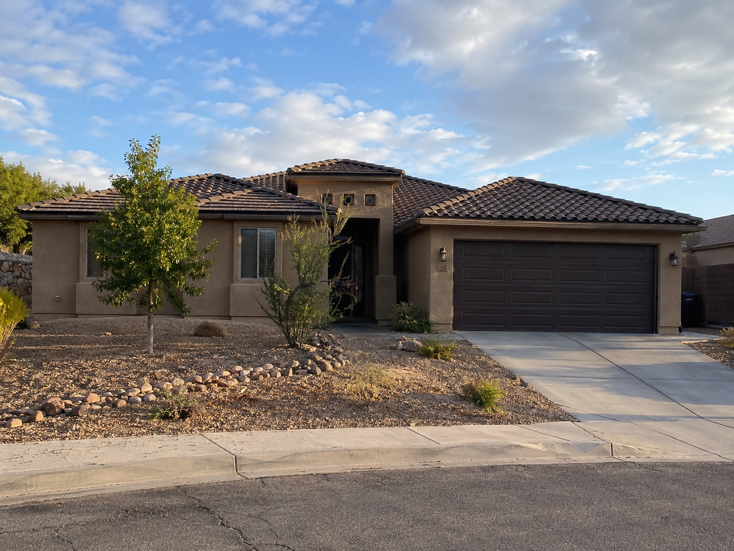 Southwest home exterior with shingle roof at golden hour