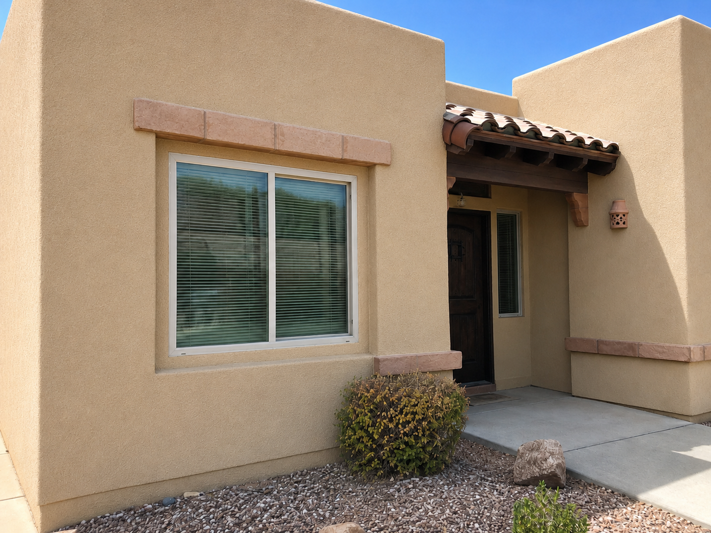 Same stucco wall with the finish blended and matched to the surrounding exterior
